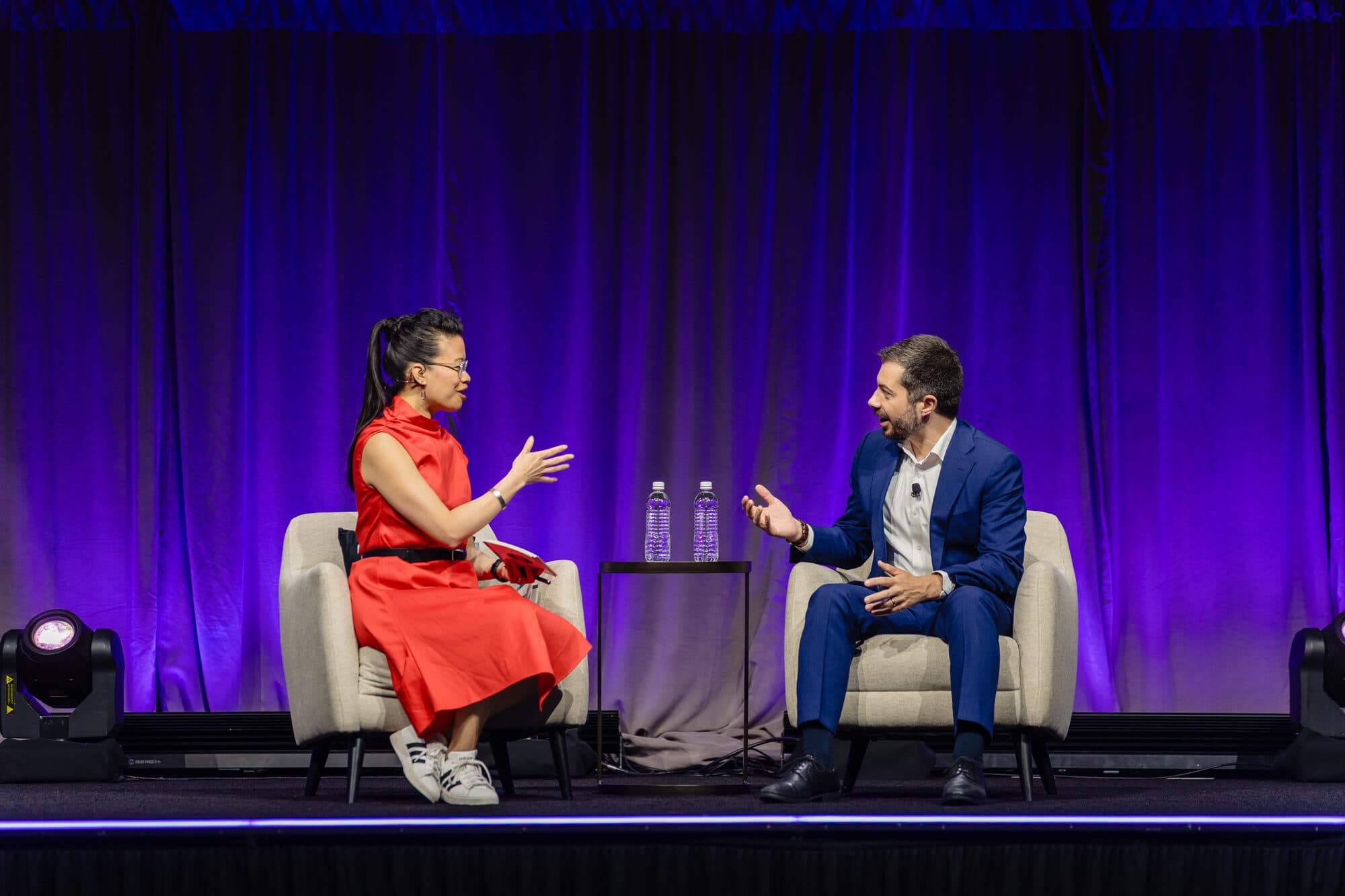 Evelyn Lee on stage with Pete Buttigieg during the AIA25 Conference keynote, June 2025.