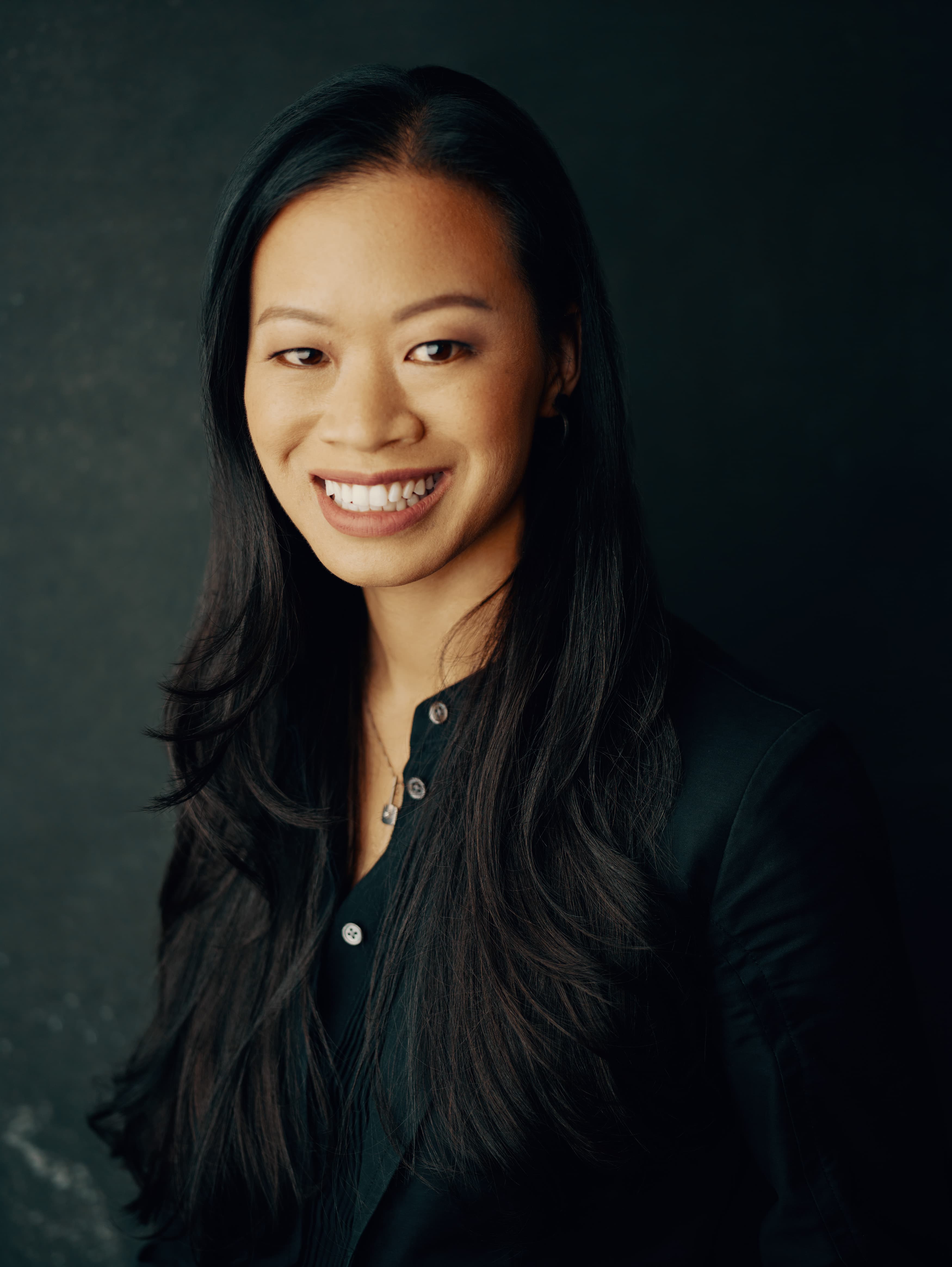 Evelyn Lee, FAIA, architect and keynote speaker, in a warm portrait.